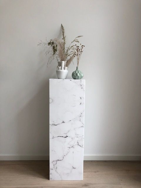 Colonna in cartone effetto marmo bianco. Di grande effetto per mostrare i tuoi accessori o pro-dotti. Facile da piegare, aprire, utilizzare, riutilizzare e trasportare